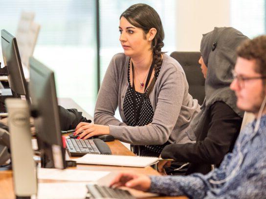 young adults working at computers together